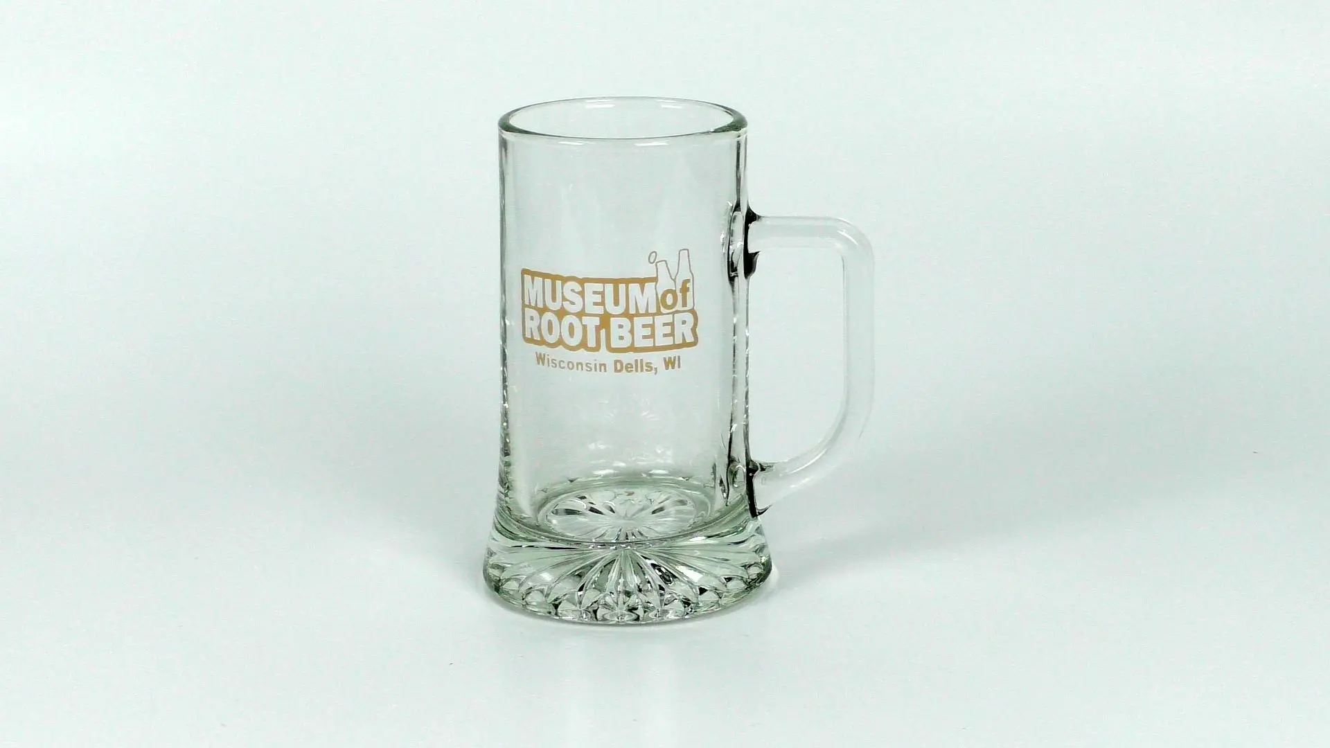 A 16 oz glass mug featuring the text "Museum of Root Beer, Wisconsin Dells, WI," capturing the essence of a traditional beer museum, shown empty against a simple backdrop.